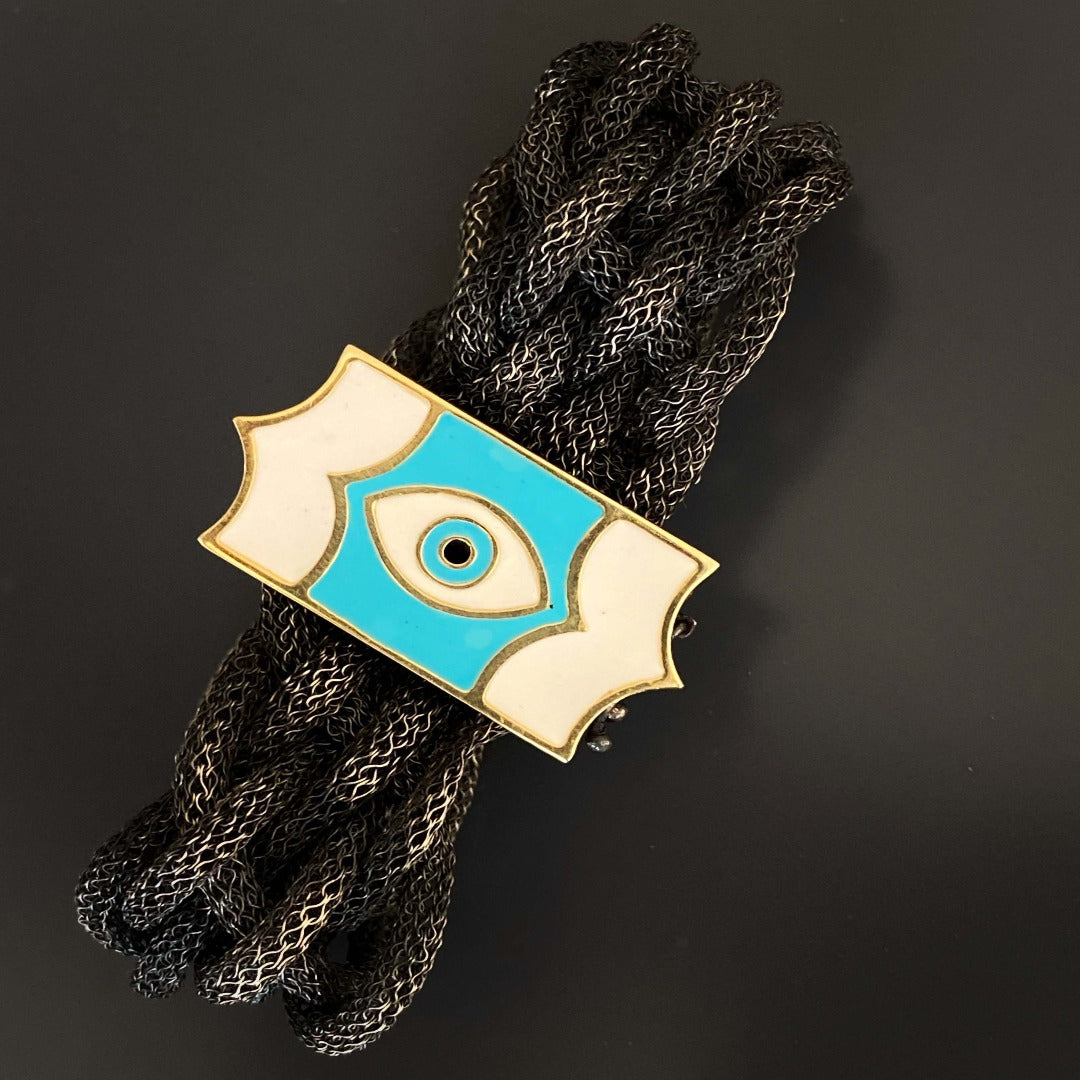 Adorn your wrist with the Silver Braided Evil Eye Bracelet, a symbol of style and protection against negativity.