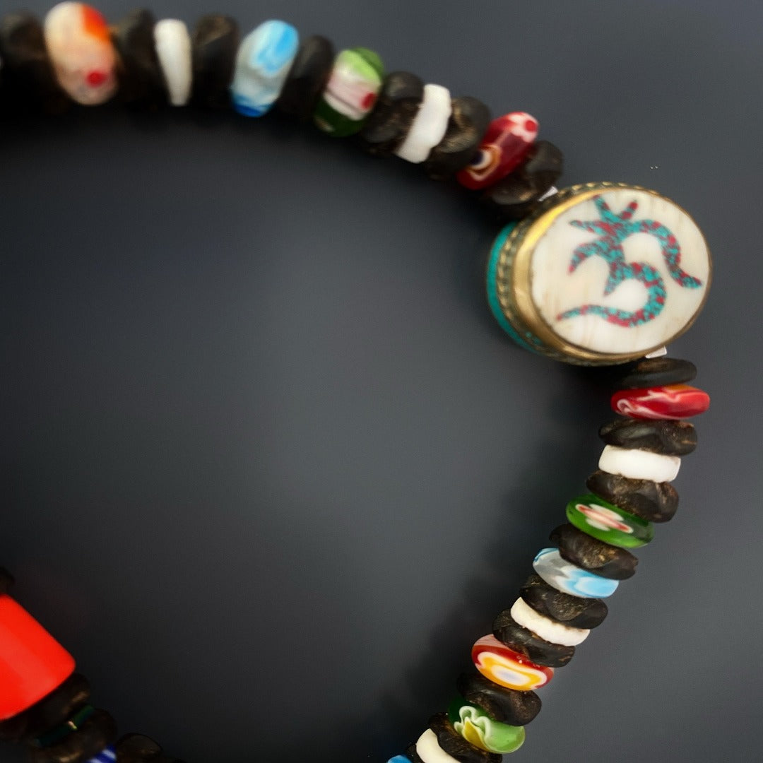 Experience the beauty and mindfulness of the Om Yoga Ankle Bracelet, meticulously crafted with natural wood beads and a captivating white howlite and turquoise stone OM bead.