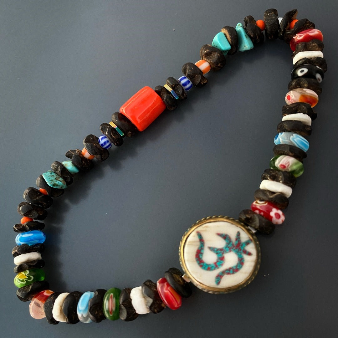Discover the spiritual essence of the Om Yoga Ankle Bracelet, adorned with unique Mille Fiori Glass beads and a handmade white howlite and turquoise stone OM bead.