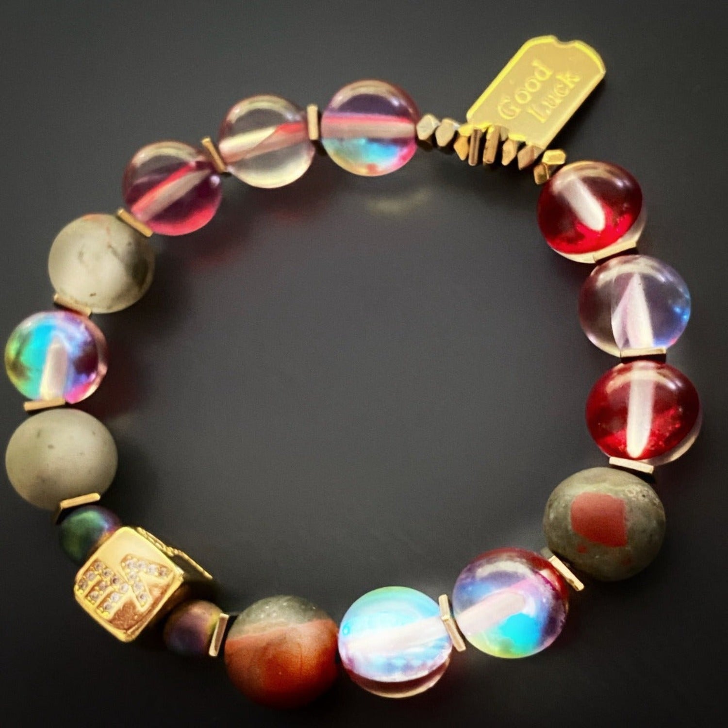 Discover the harmony of colors in the Red & Gold Good Luck Bracelet, combining red, grey, and gold tones for a stunning accessory.