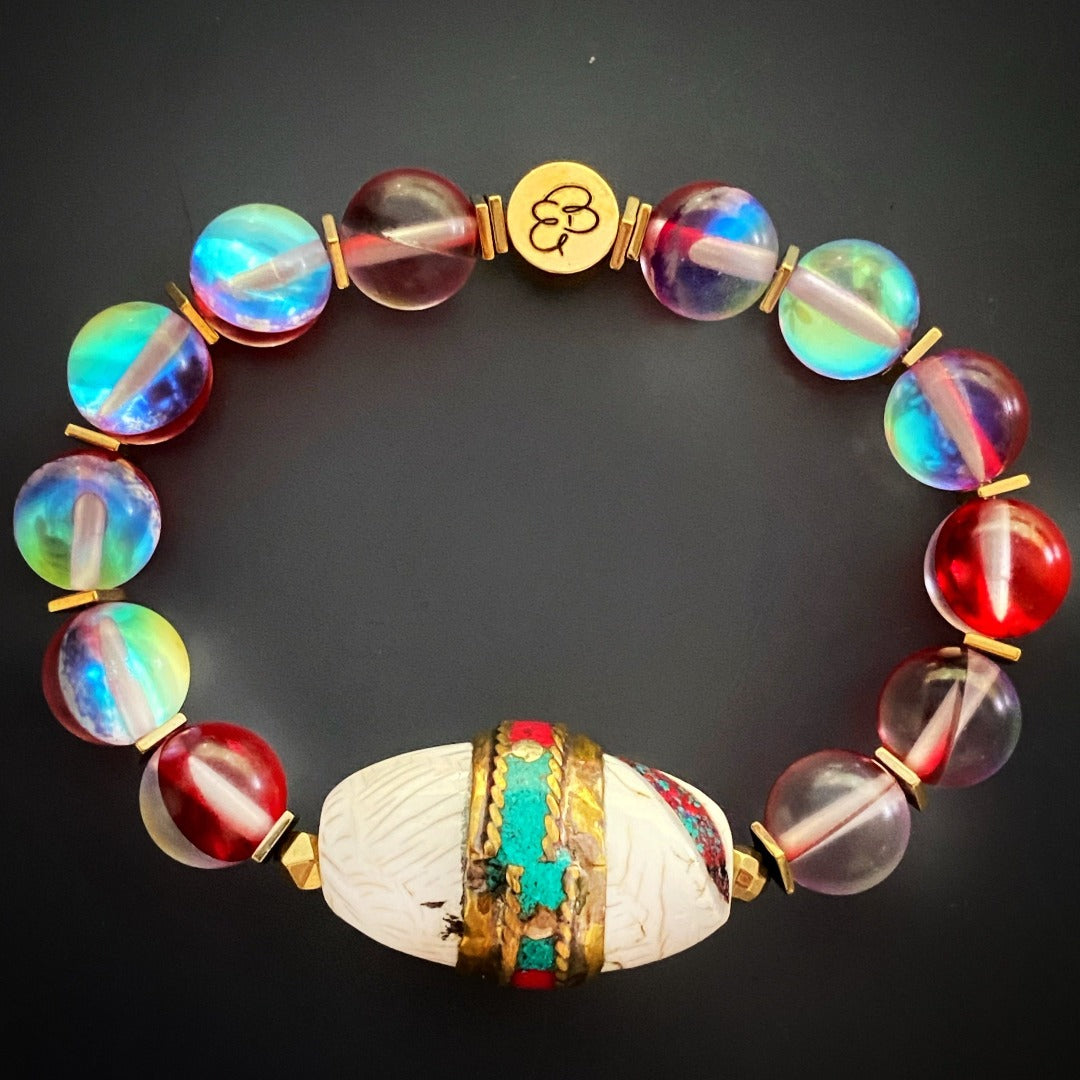 Explore the vibrant energy of the Red Cat Eye Ethnic Bracelet, combining red eye stone beads and gold-colored hematite spacers.