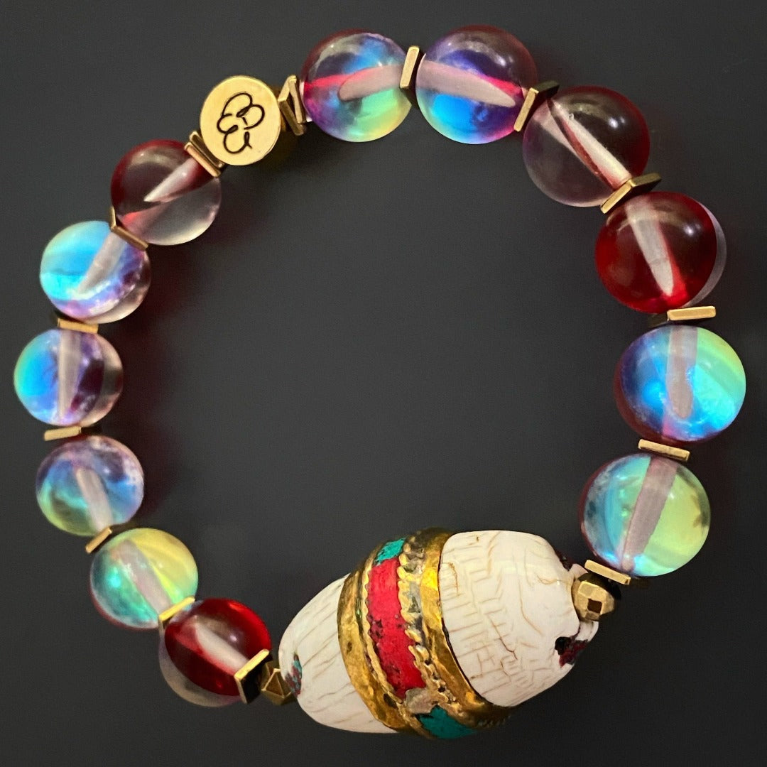 Immerse yourself in the beauty of the Red Cat Eye Ethnic Bracelet, featuring a stunning Nepal bead with turquoise and coral inlay.