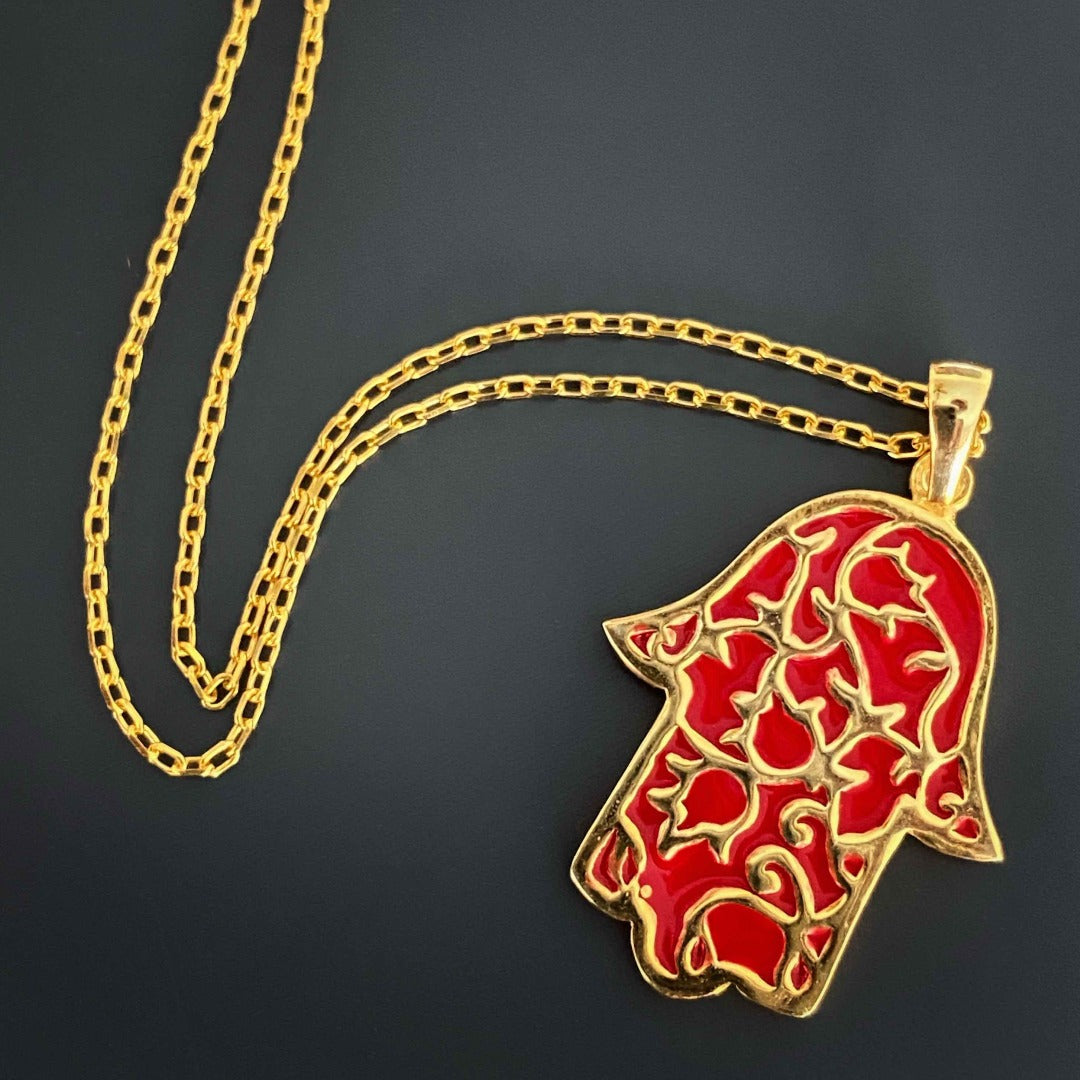 Wear the Stay Positive Hamsa Necklace as a symbol of protection and good fortune, showcasing its stunning hamsa pendant made of sterling silver and 18K gold plating with enamel accents.