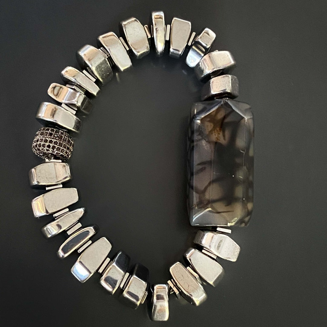 Elevate your style with the Stylish Mila Bracelet, a chic accessory featuring nugget silver color hematite beads and a captivating jasper stone.