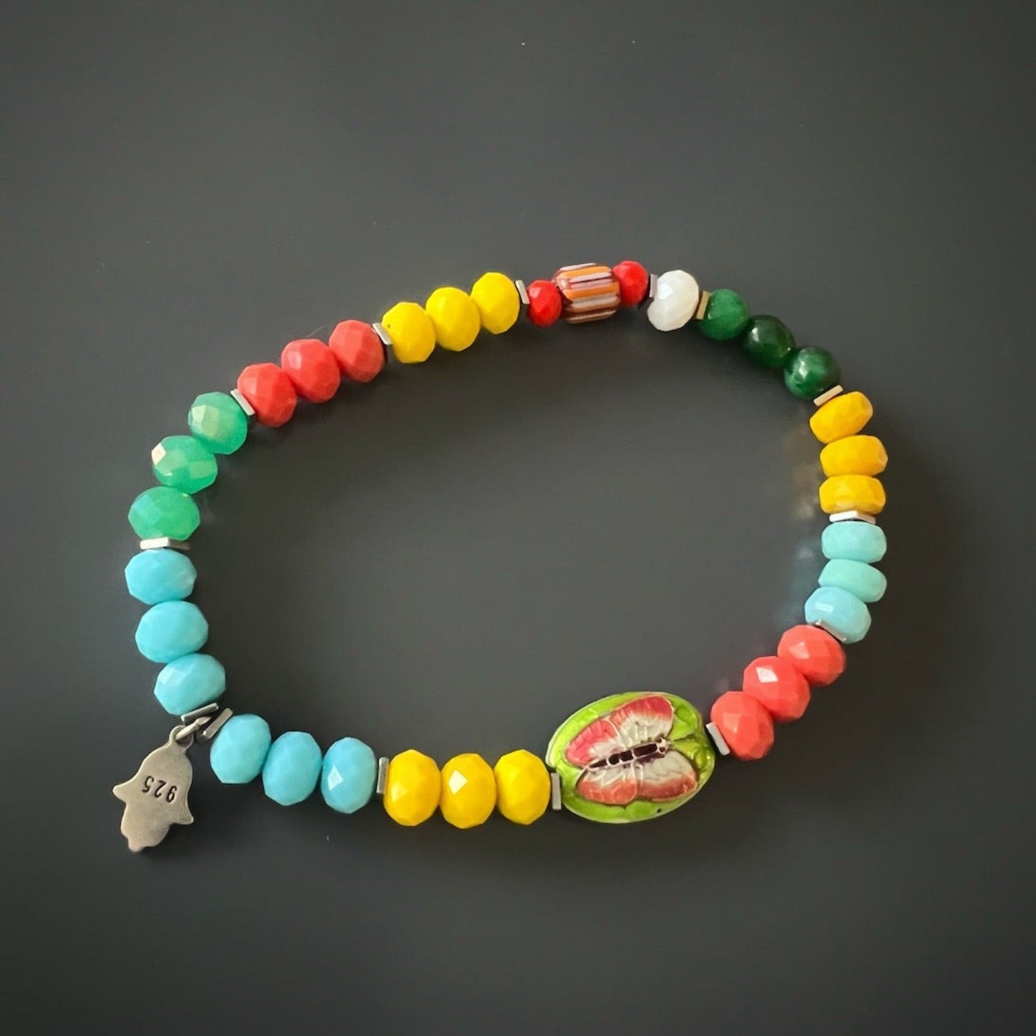 Stretch ankle bracelet with colorful summer tones and protective charm.