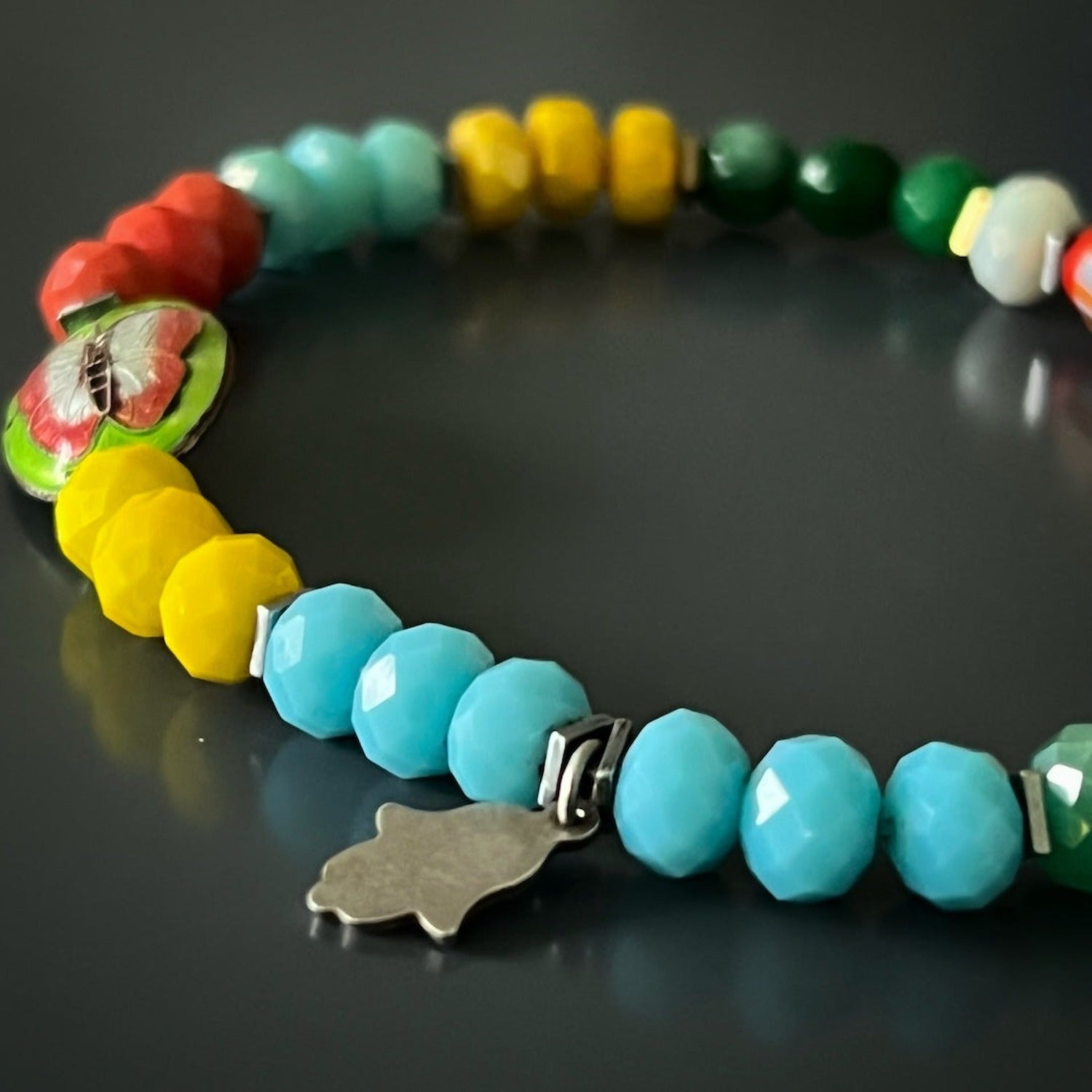 Handmade anklet with rainbow crystal beads and whimsical butterfly charm.