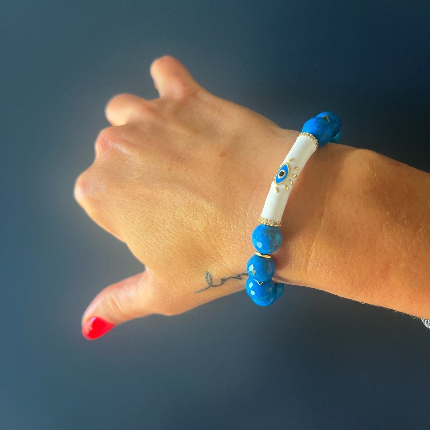 The hand model elegantly showcases the Turquoise Inner Calm Bracelet, embodying the serenity and style it brings to any ensemble.