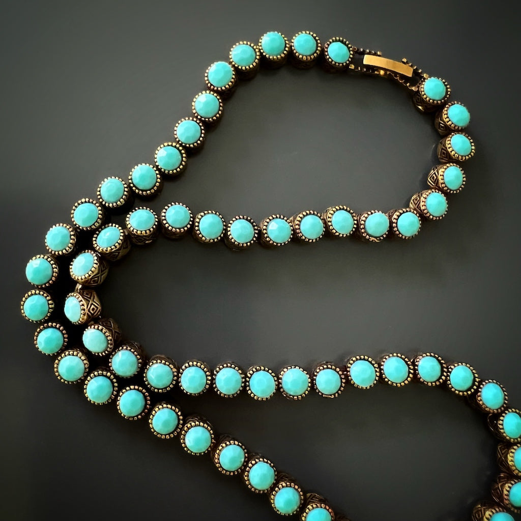 A close-up image of the turquoise tennis necklace, highlighting its beautiful bronze craftsmanship and vibrant turquoise stones.