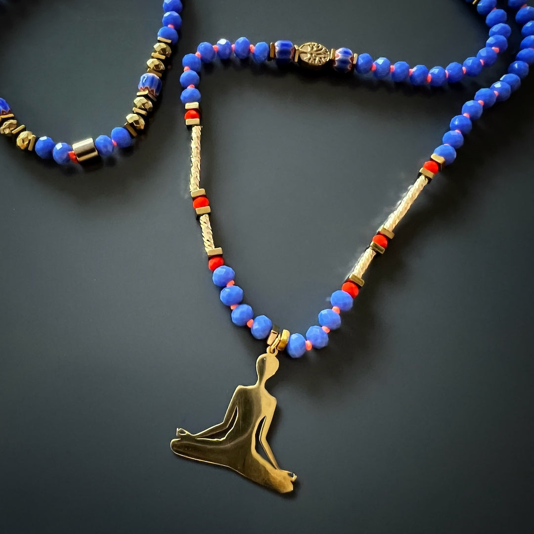 Necklace showcasing the beauty of blue crystal beads, gold hematite spacers, and a Nepal Om Mani Padme Hum mantra bead, perfect for meditation practice.
