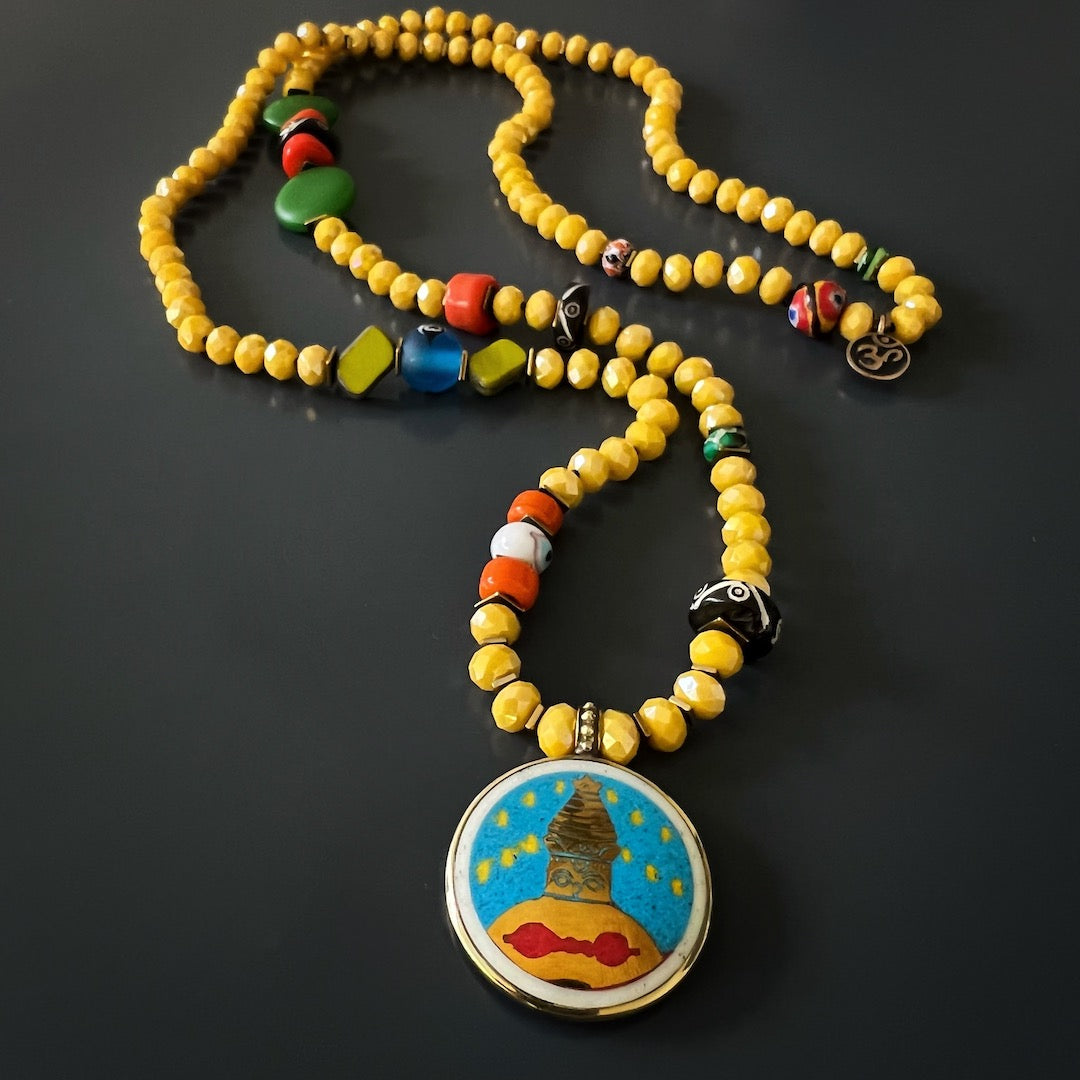 Embrace the spiritual energy of the Yoga Serenity Necklace with its colorful African beads and symbolic charms.