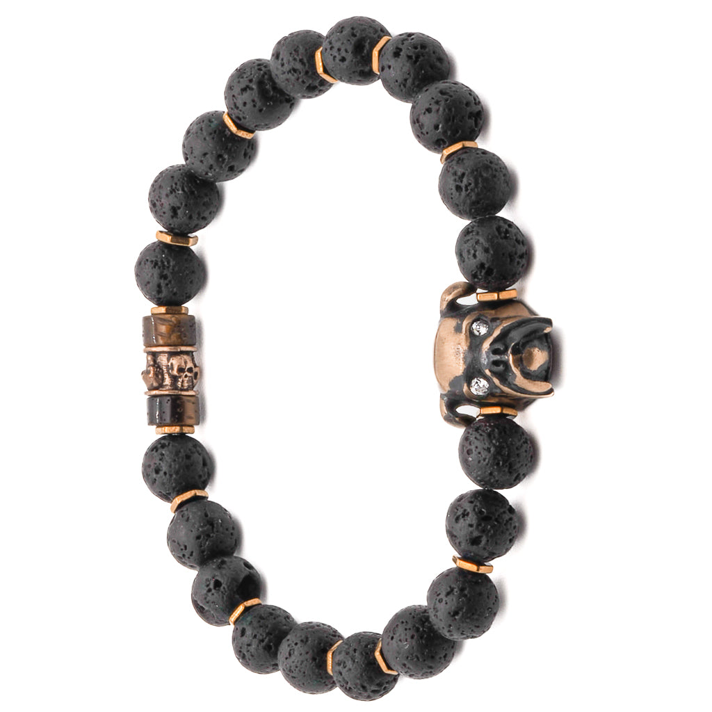 Close-up of bronze dog charm with zircon eye on black lava rock beaded bracelet.