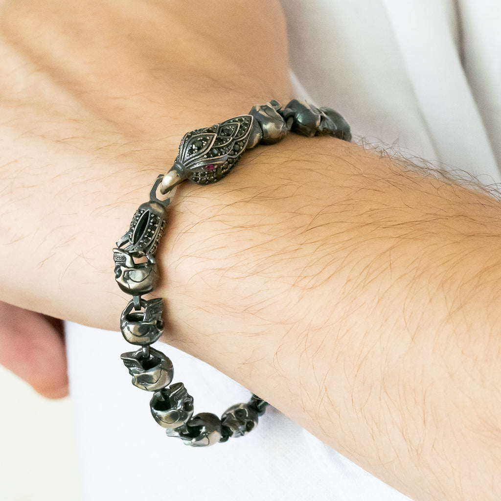 A photograph featuring a hand model wearing the Designer Eagle and Skull Bracelet, displaying how it elegantly adorns the wrist and adds a touch of edgy sophistication to any ensemble.