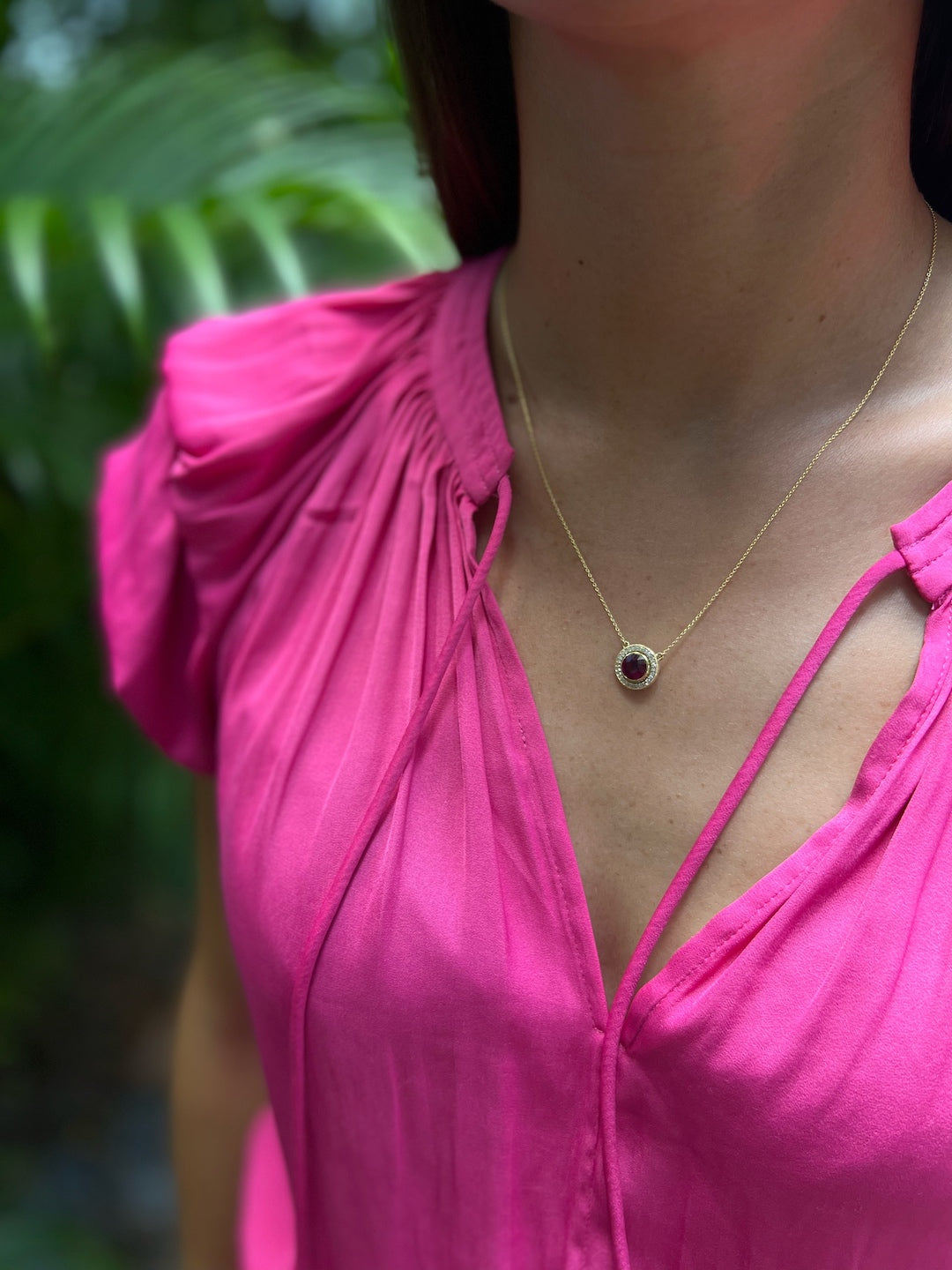 The Elegant Ruby & Diamond Necklace beautifully adorning the model's neckline, symbolizing love, passion, and protection with its vibrant ruby and dazzling diamonds.