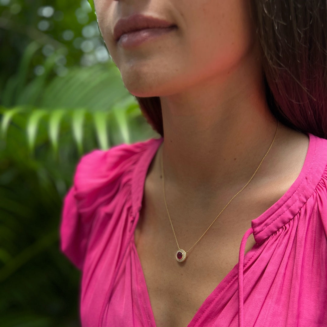 Model wearing the stunning 14k yellow gold necklace with a natural ruby and diamonds, adding a touch of luxury and allure to her look.