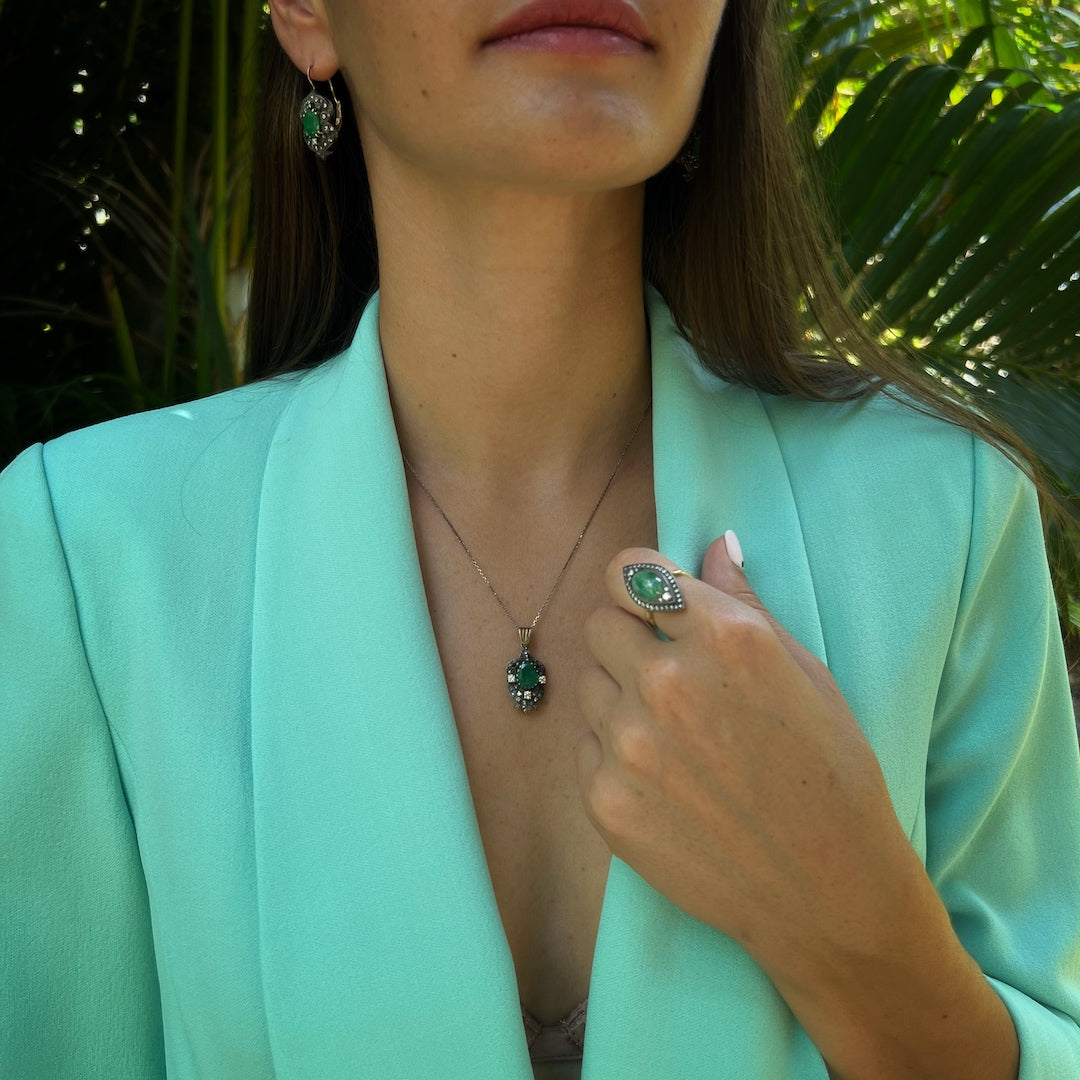 Hand model wearing the Emerald & Diamond Eye Ring, capturing attention with its timeless design, brilliant gemstones, and exceptional quality craftsmanship.