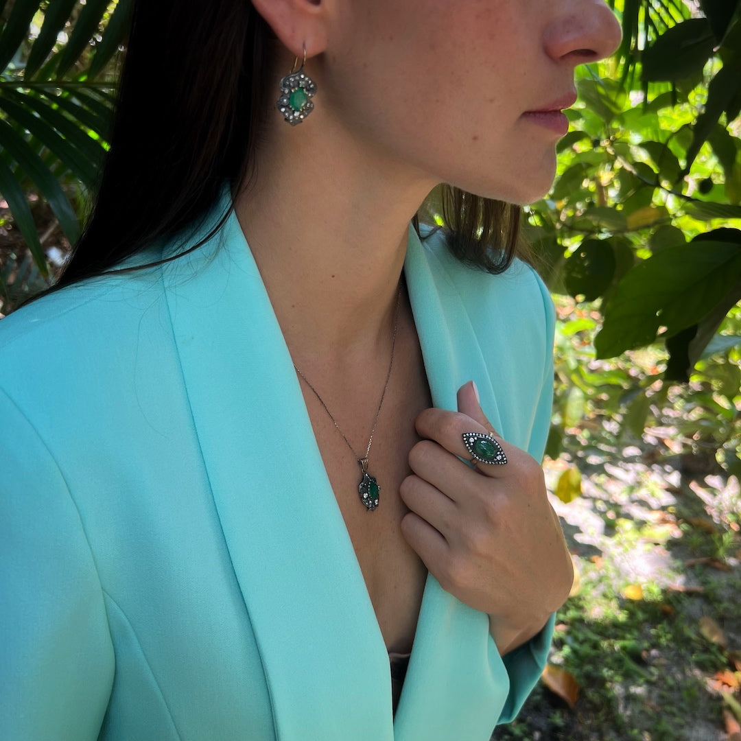 Hand model wearing the exquisite Emerald & Diamond Eye Ring, radiating elegance and sophistication with its vibrant emerald and diamond accents.