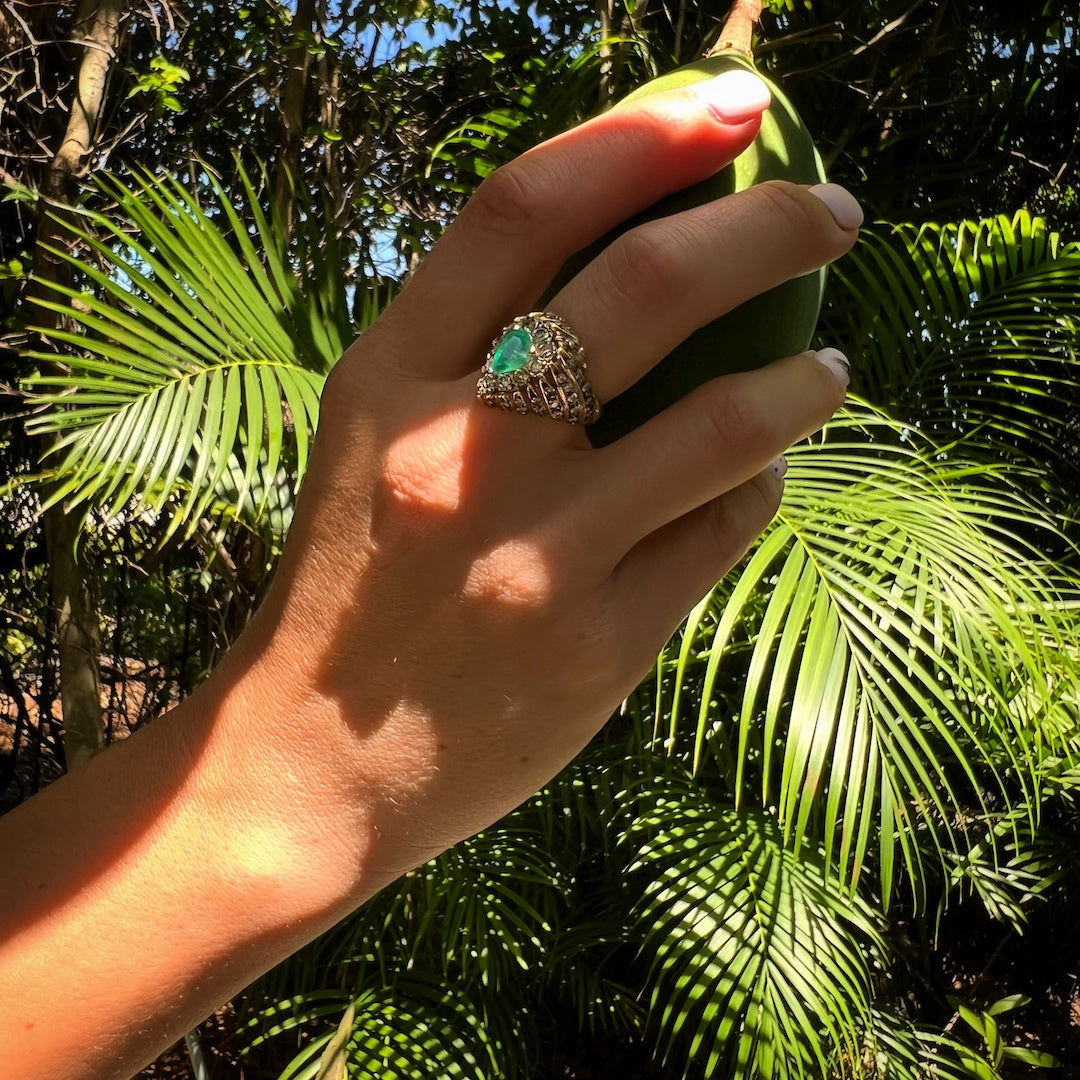 Hand model showcasing the Emerald & Diamond Eye Ring, capturing attention with its captivating emerald and dazzling diamonds, perfect for adding a touch of luxury to any ensemble.