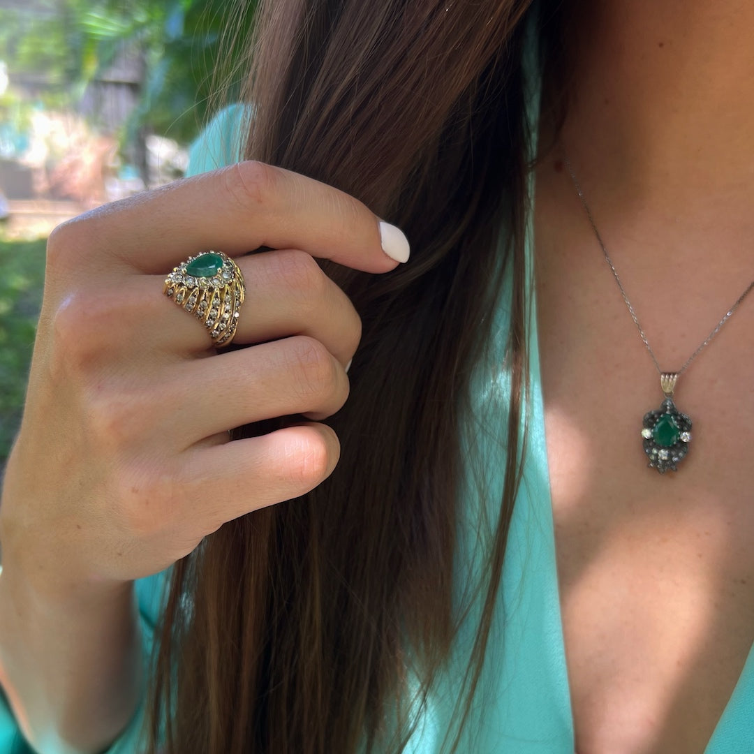 Hand model wearing the luxurious Emerald & Diamond Eye Ring, a true statement of elegance and refinement with its exquisite gemstones and fine craftsmanship.