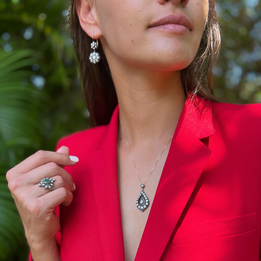 Hand model showcasing the exquisite Emerald Star Ring, featuring a stunning emerald centerpiece surrounded by sparkling diamonds, radiating elegance and charm.