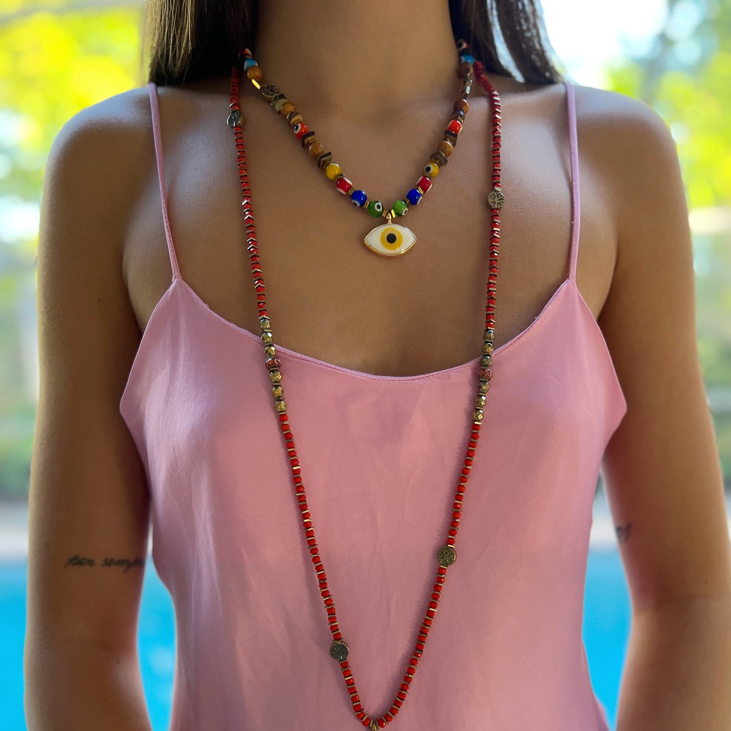 Model wearing Evil Eye Beaded Necklace - A model wearing the stunning Evil Eye Beaded Necklace, showcasing its vibrant colors and intricate design.