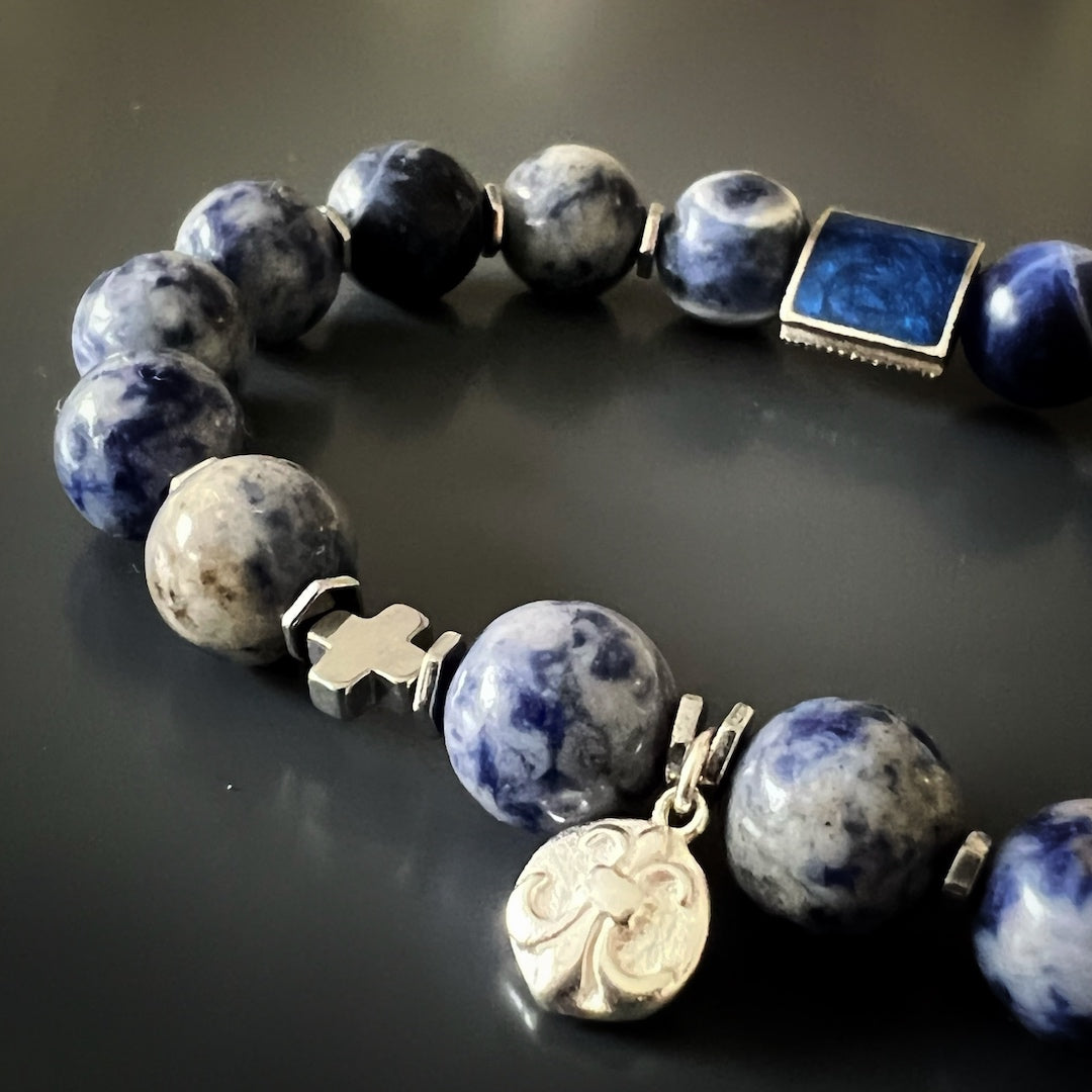 Meaningful Sodalite Bracelet - Handcrafted jewelry with sodalite beads and a sterling silver fleur de lis charm, symbolizing purity and light.