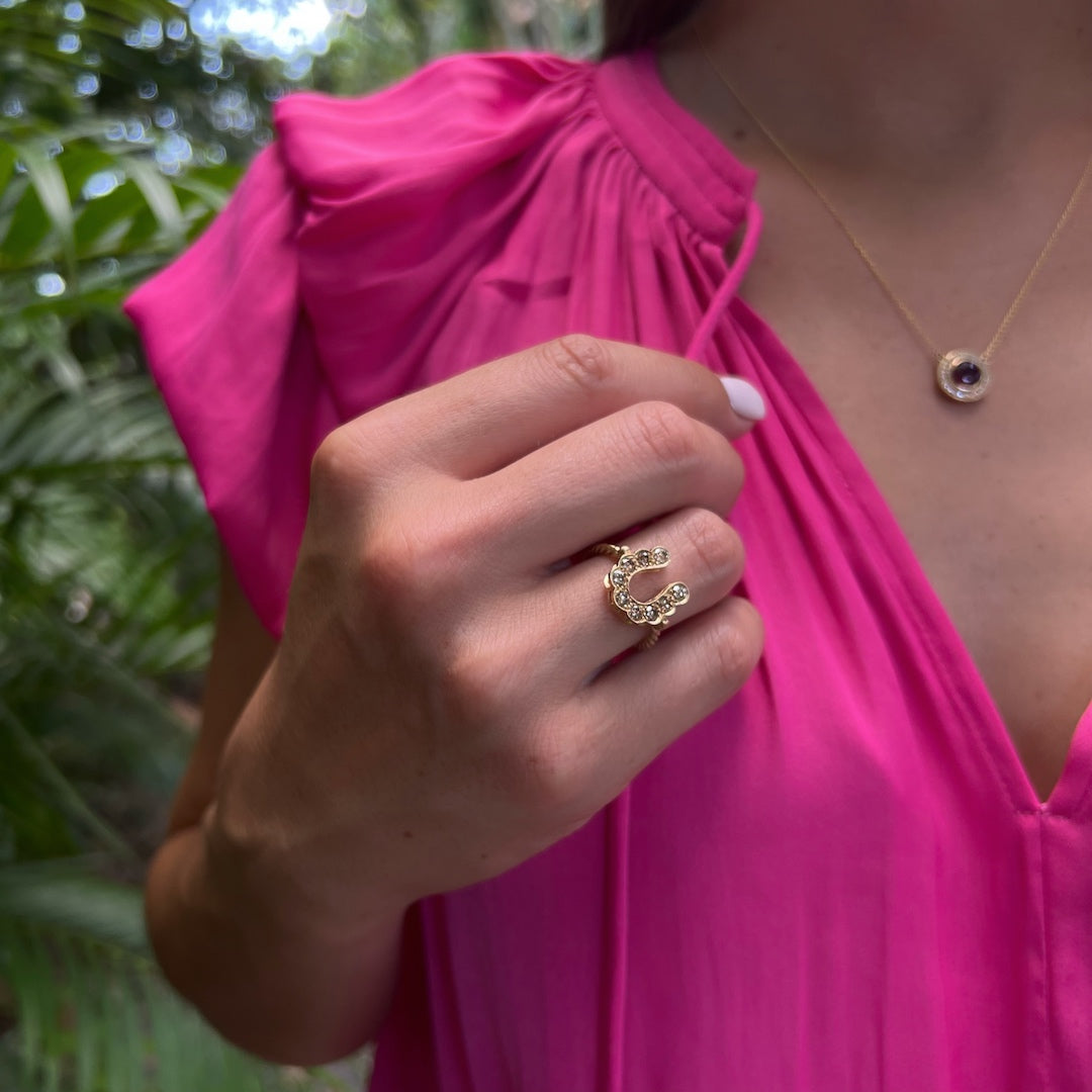 Gold and Diamond Horseshoe Ring on Hand - An alluring shot of the 14k yellow gold ring with chocolate diamonds, elegantly adorning the hand of a model.