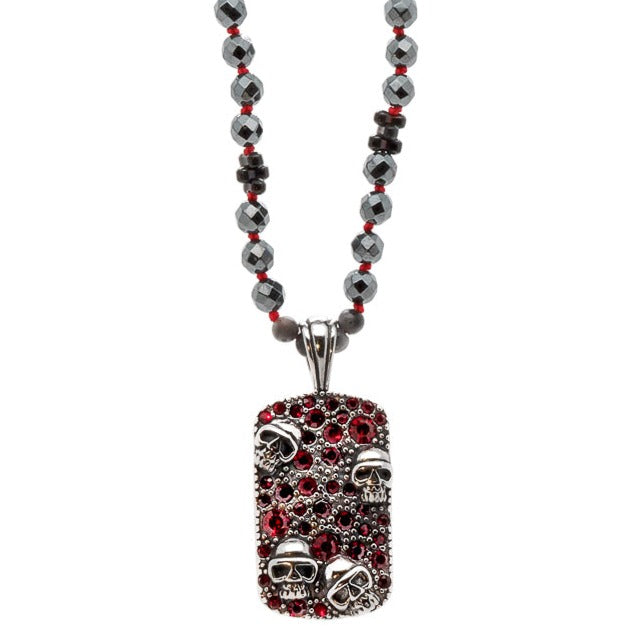 The Gothic Red Skull Necklace is a striking piece of jewelry that showcases a bold and edgy design. The necklace features a combination of Hematite stone beads, Silver hematite plus beads, and a Steel unique skull pendant with red color zircon crystals.