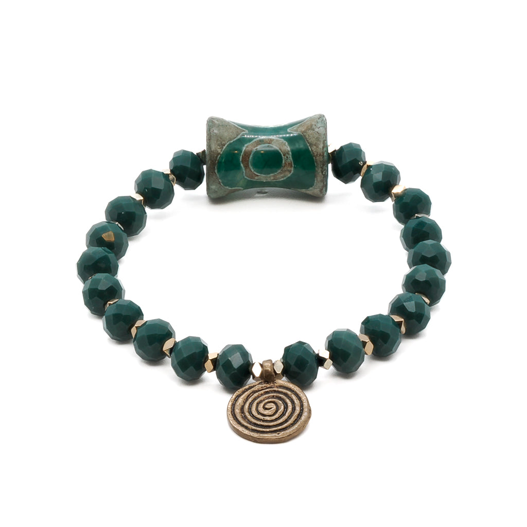 A close-up view of the Green Spiral Bracelet, highlighting the vibrant green crystal beads and the elegance of the gold hematite spacers.