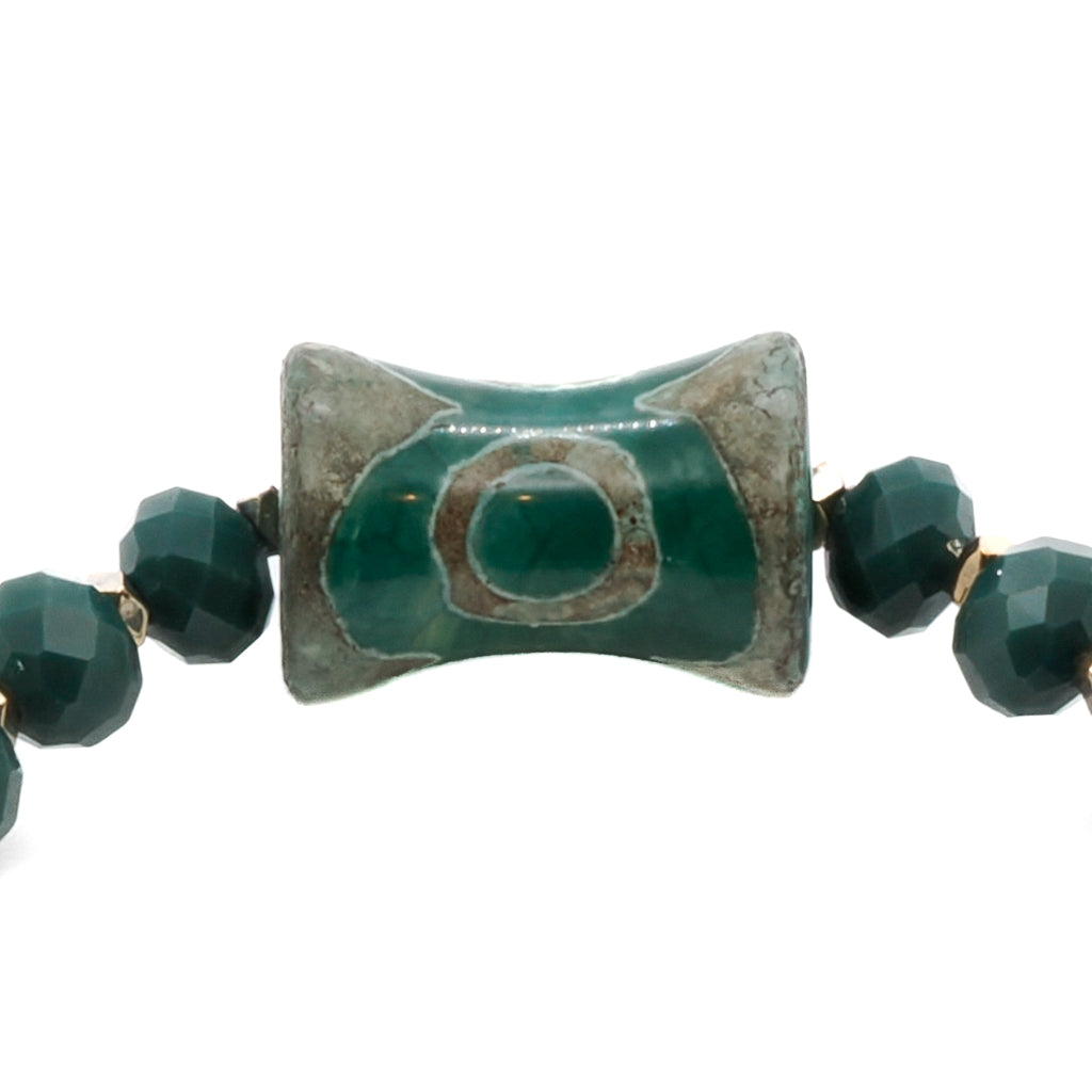 A detailed view of the Green Spiral Bracelet, focusing on the intricate design of the big green eye Nepal bead.
