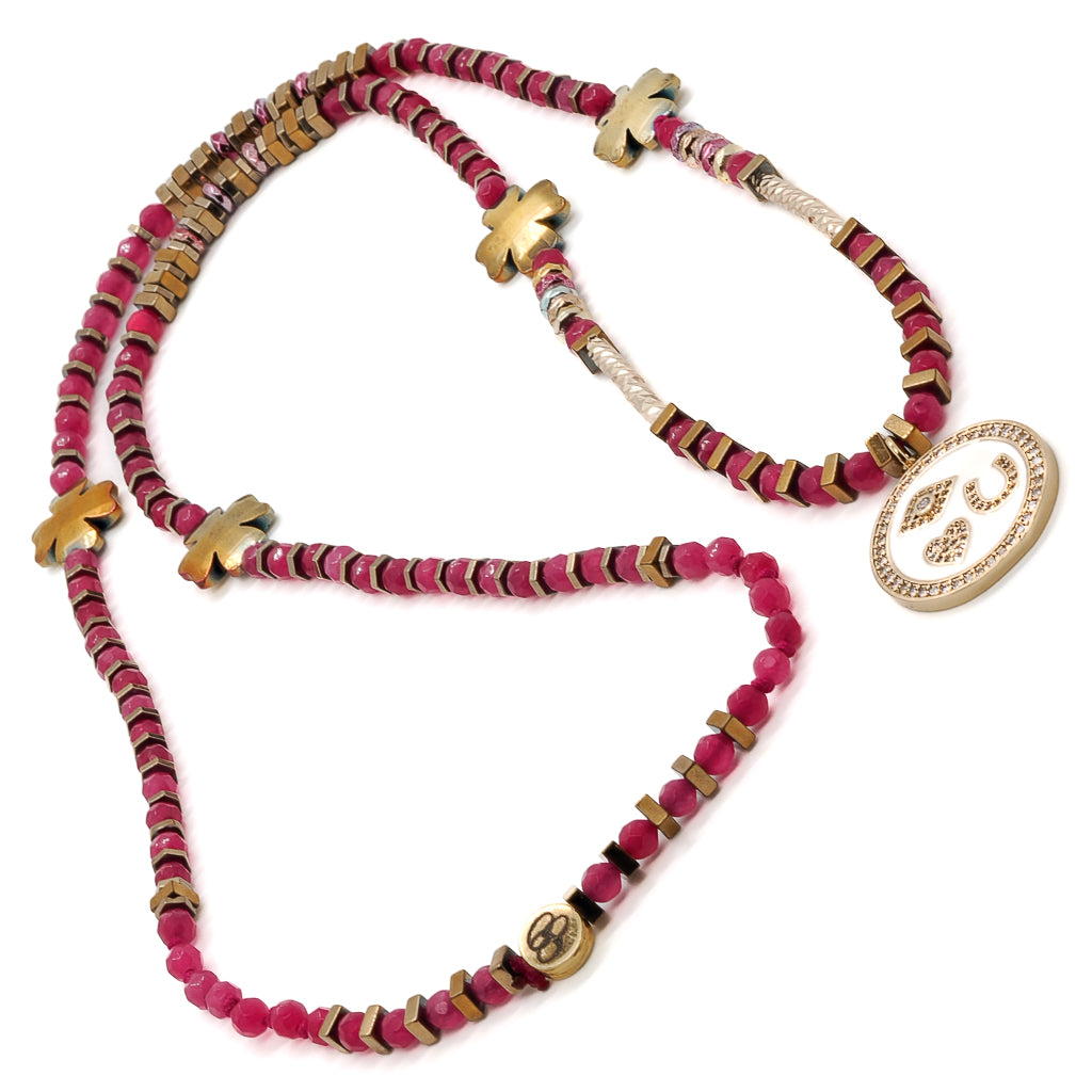 Elevate your style with the Magic Blessings Pink Necklace, showcasing a combination of protective symbols, including an evil eye, horseshoe, heart pendant, and lucky flowers, a stunning accessory handcrafted with hot pink faceted jade stone beads and gold-colored hematite spacers.