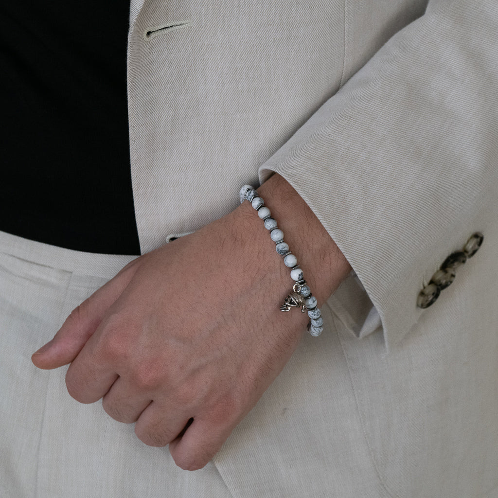 See the Men's Spiritual Beaded Skull Bracelet add an edgy touch to the model's ensemble.
