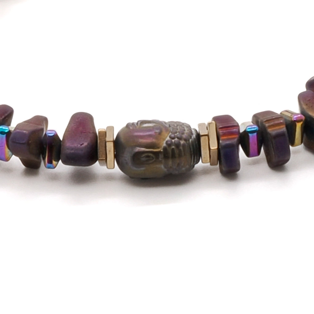 Explore the beauty of the Mystic Buddha Bracelet, with its Hematite Buddha bead and the shimmering gold and multi-color hematite stone spacers, reflecting tranquility and inner peace.