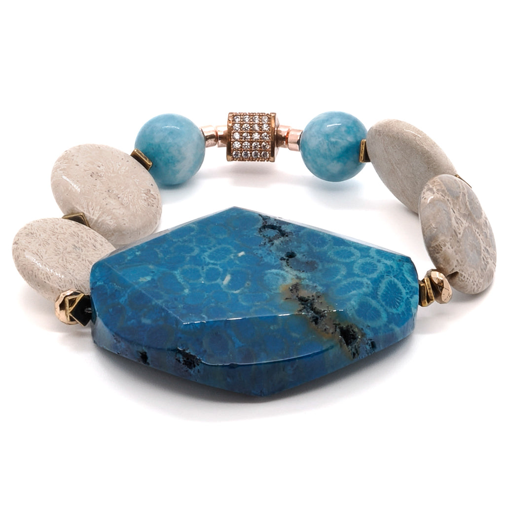 Discover the sophistication of the New World Bracelet, handcrafted with blue agate gemstone beads and adorned with gold hematite spacers.