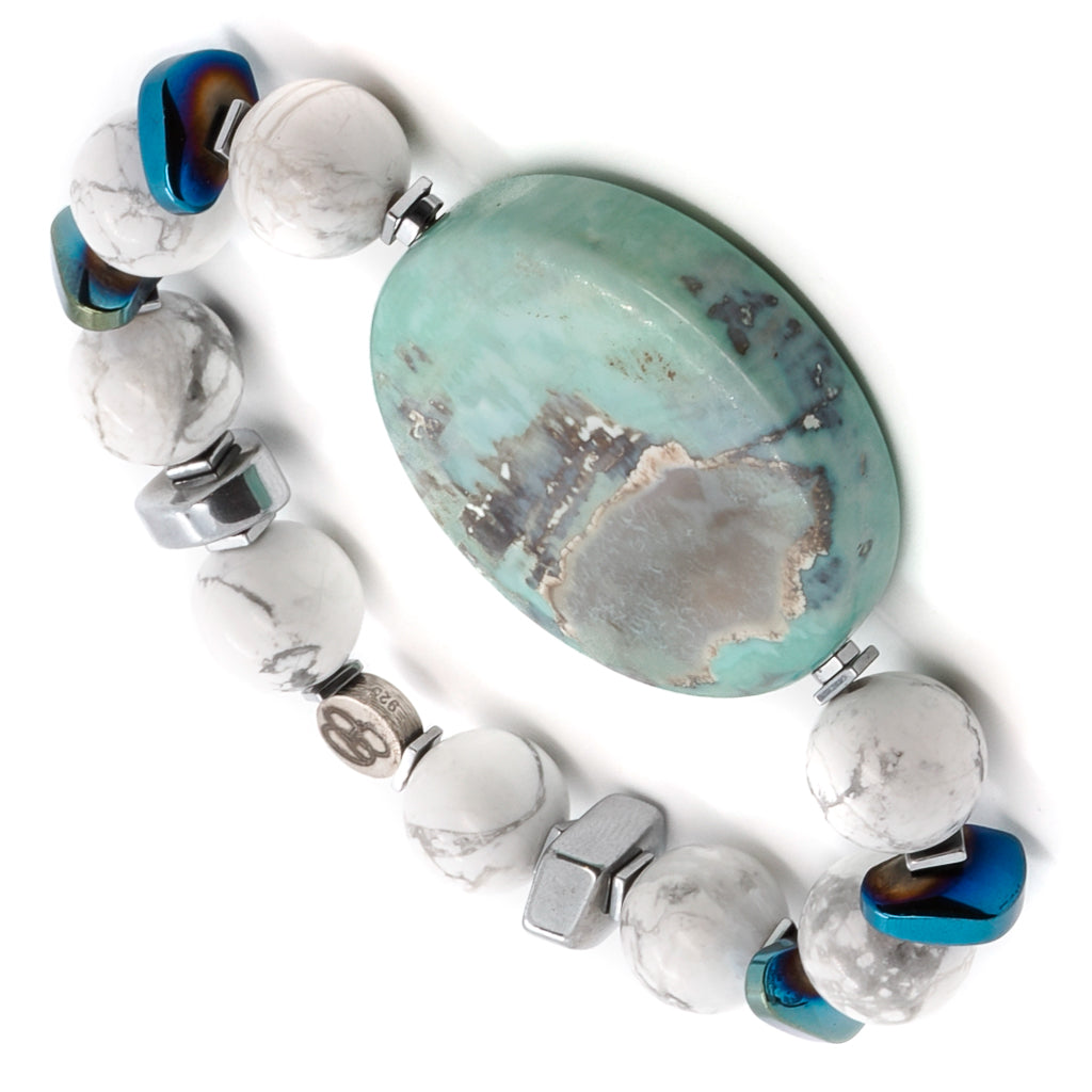 Dive into the mesmerizing design of the Ocean Bracelet, showcasing the calming properties of ocean jasper and howlite stones.
