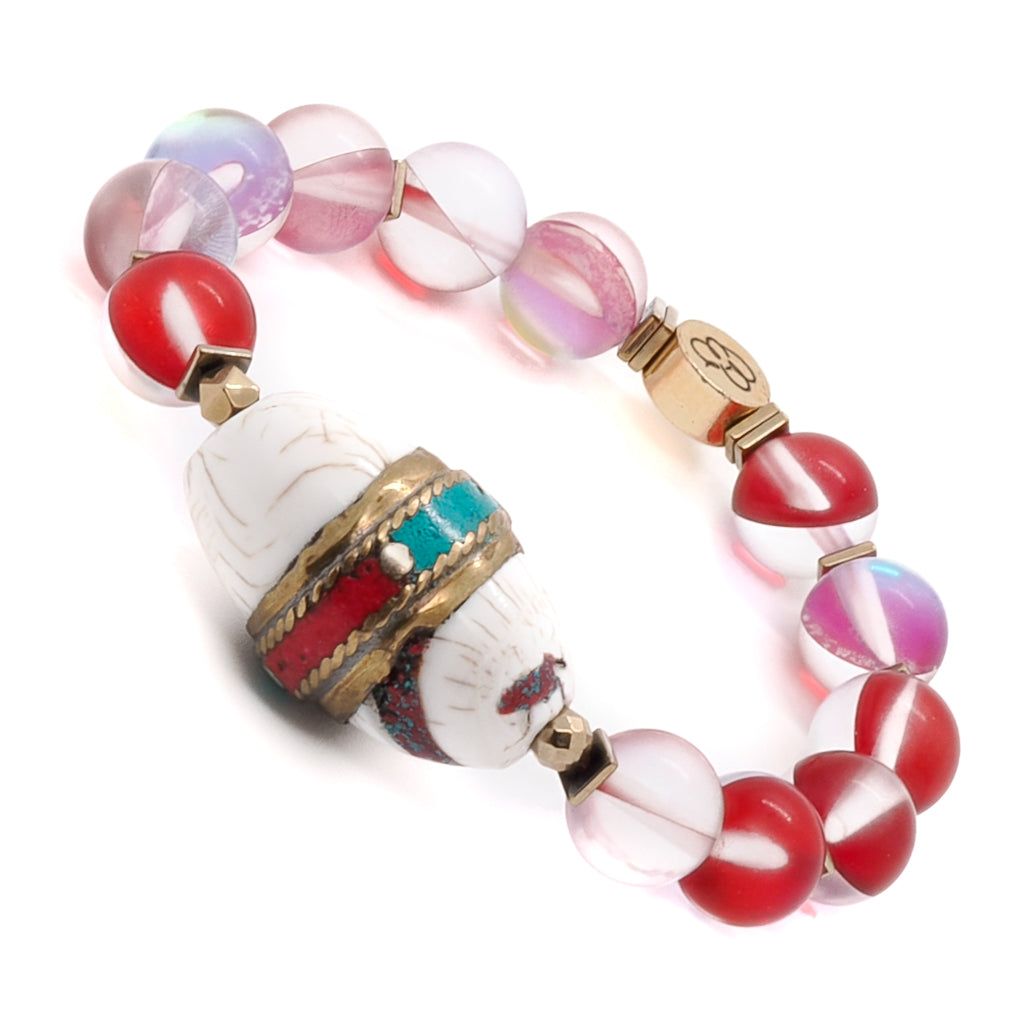 Admire the unique design of the Red Cat Eye Ethnic Bracelet, featuring a focal Nepal bead with turquoise and coral inlay.