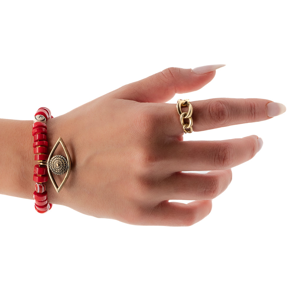 Hand model showcases the unique style and spiritual power of the Red Coral Evil Eye Bracelet, adorned with red coral beads and an eye-catching evil eye charm.