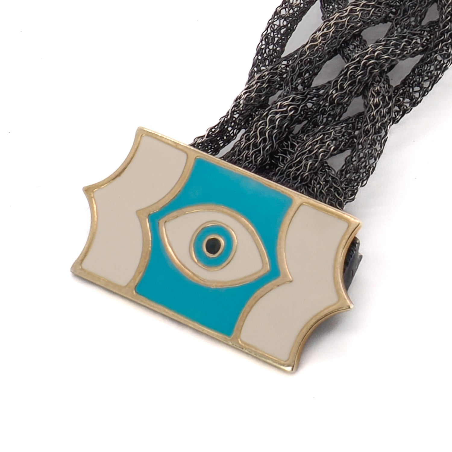 Admire the craftsmanship of the Silver Braided Evil Eye Bracelet, showcasing a handmade sterling silver band and a symbolic evil eye clasp.