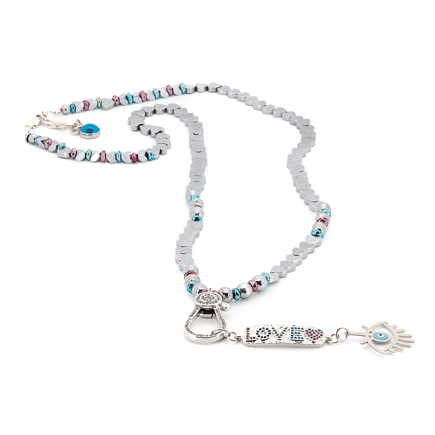 Detailed shot of the intricate silver love pendant with zircon stones