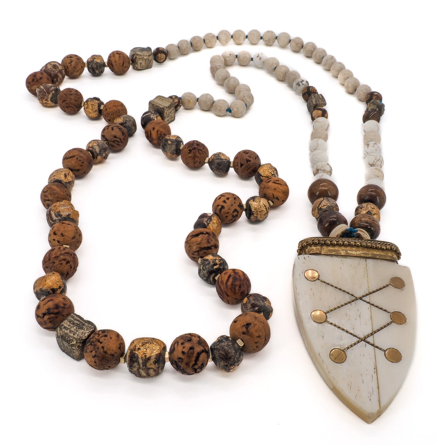 Adorn yourself with the elegance of the Spirits on the Run necklace, featuring white agate stones and a captivating Nepal pendant.