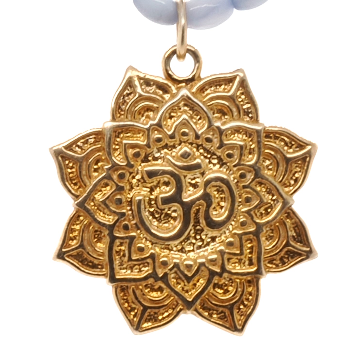 Handmade necklace featuring blue mother of pearl beads and a Buddhist Om mantra pendant.