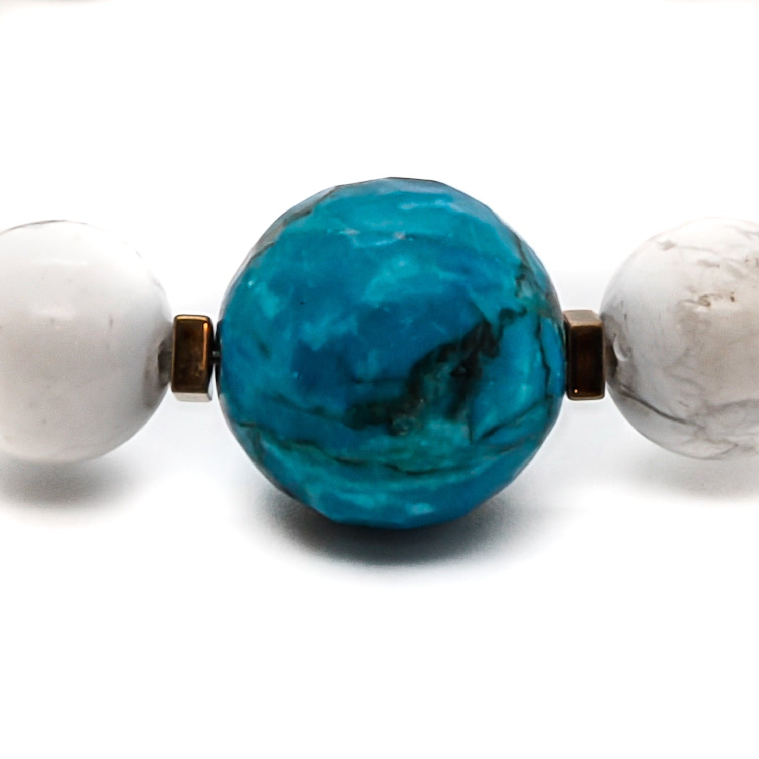 Discover the harmonious combination of turquoise, howlite, and red coral in the elegant Turquoise Balance Bracelet.