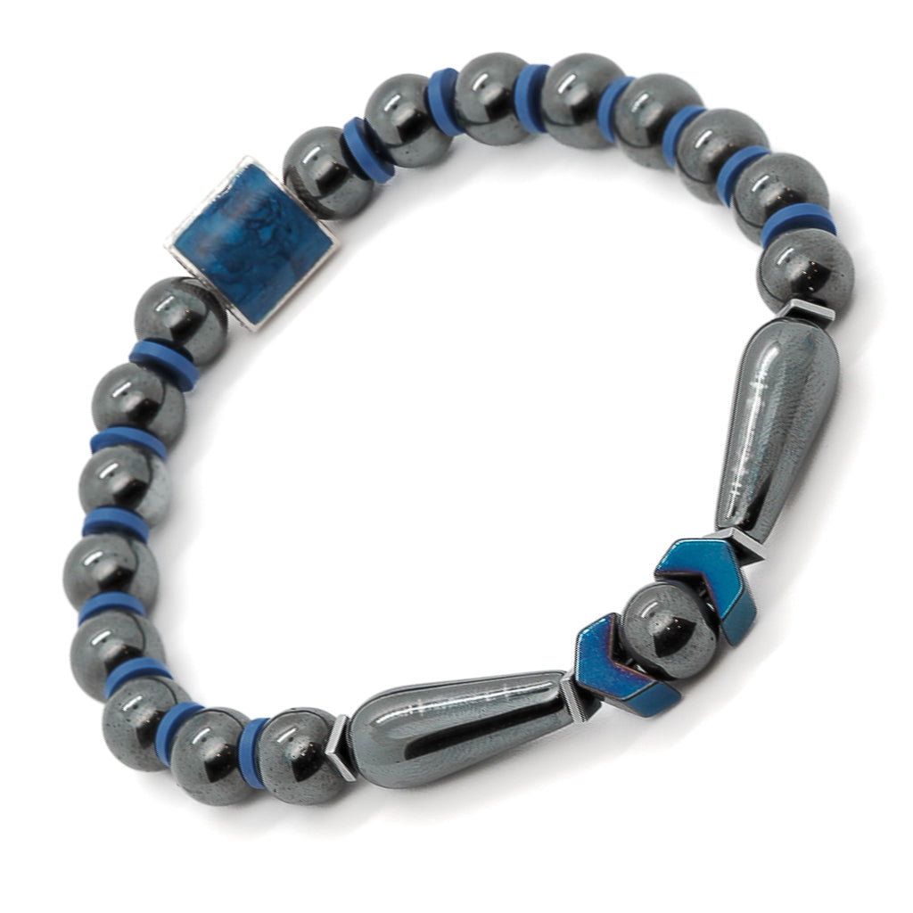 Close-up of unique hematite bracelet with silver lapis inlay bead and arrow-shaped accents.