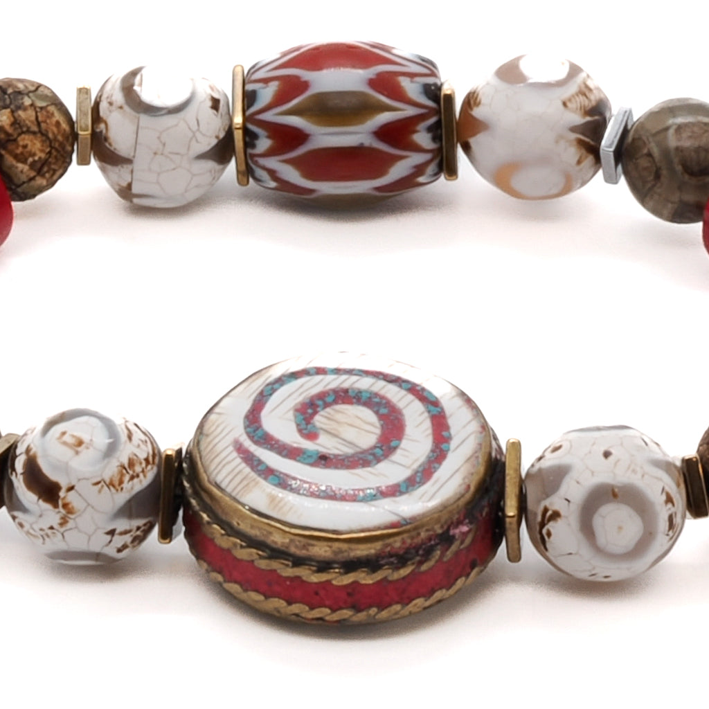Experience the beauty and spirituality of the Yoga Spirit Mystic Bracelet, adorned with rondella coral stone beads, Nepal meditation beads, and a colorful African bead.