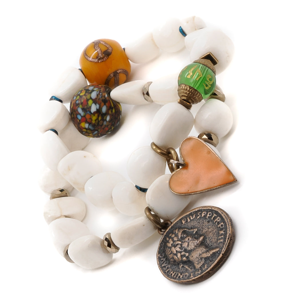Experience the peace and spirituality of the Zen Bracelet Set, crafted with Tibetan White Stone Beads and adorned with symbolic charms.