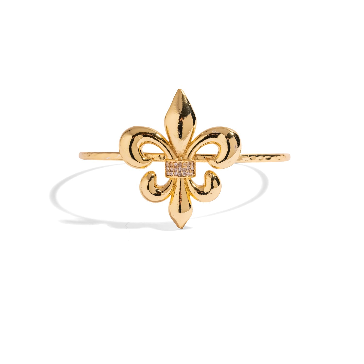 Slim gold cuff bracelet with a large polished fleur de lis and pave crystal band