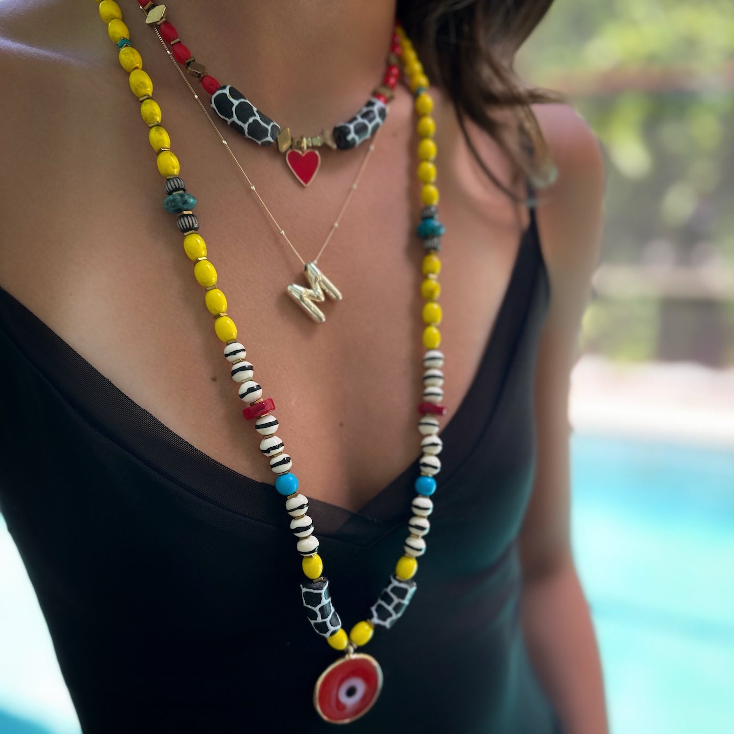 Model showcasing the Nepal yellow beads and turquoise stones on the African Yellow Happiness Necklace.