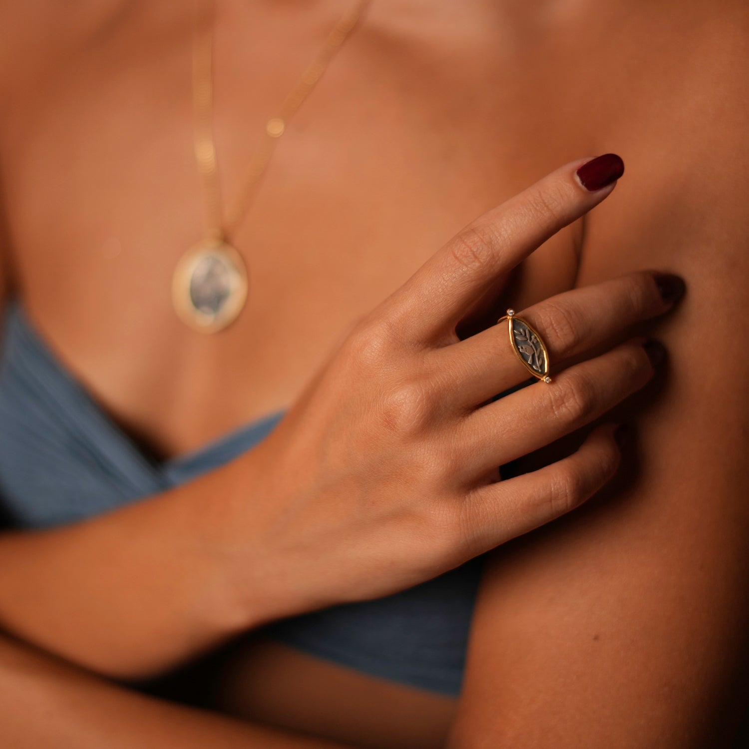 Beautifully crafted sterling silver signet ring with olive leaf and bird motifs, bordered by 18k gold plating