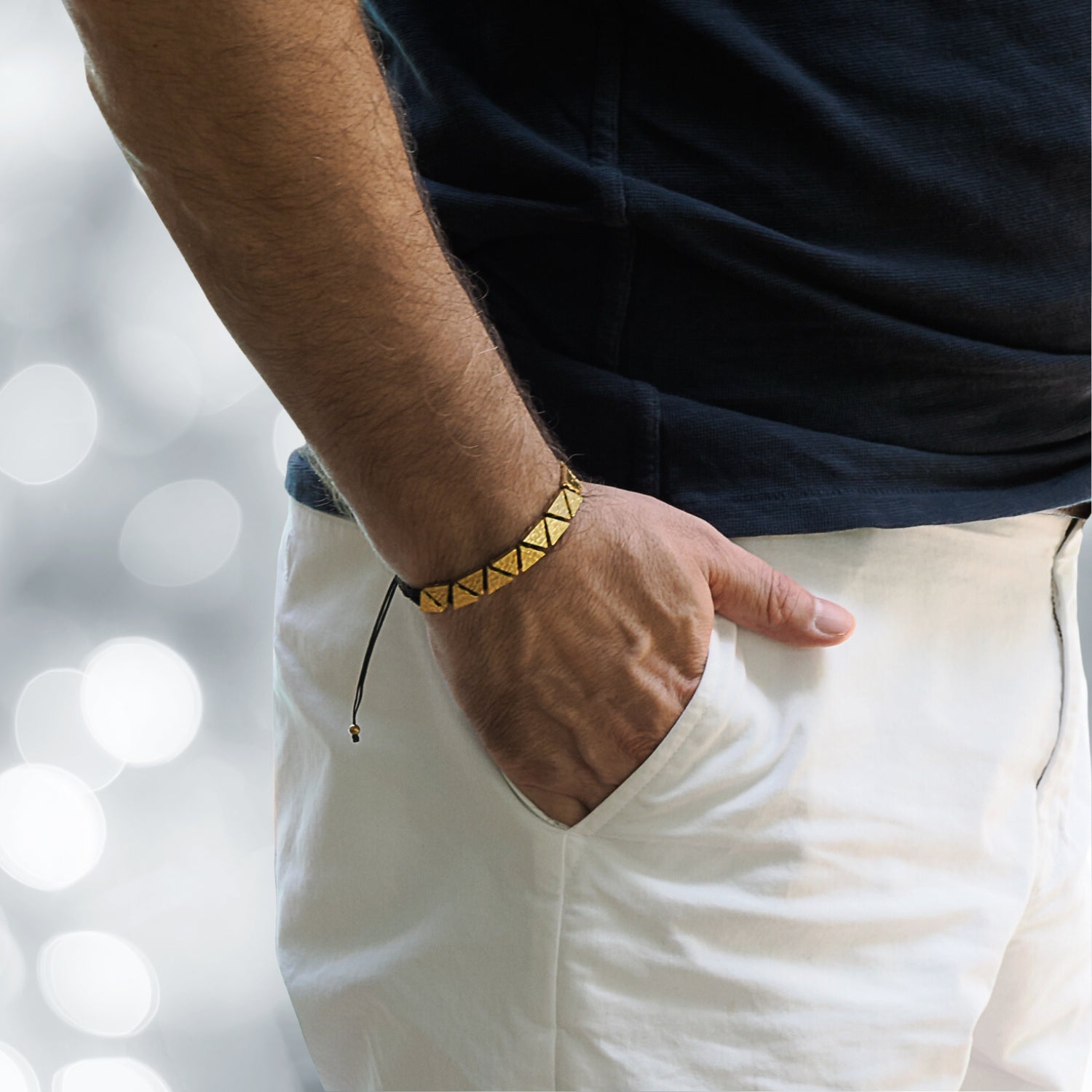 Model Showcasing the Black and Gold Triangle Bracelet with Elegance