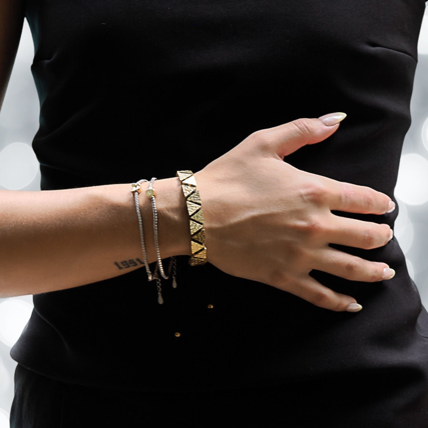Black and Gold Triangle Bracelet on a Model - A Perfect Blend of Style and Meaning