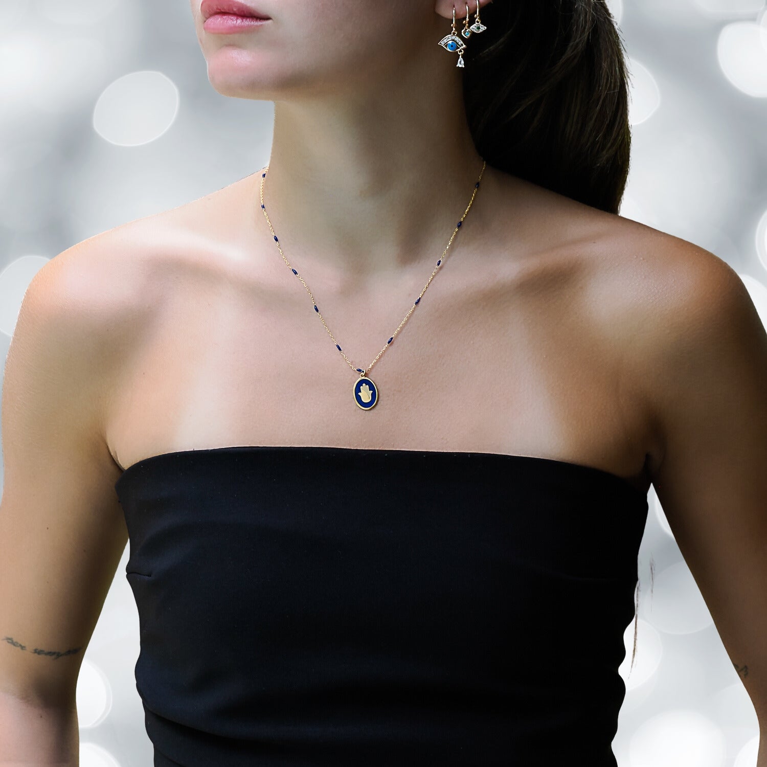 Model Adorning the Blue Enamel Hamsa Talisman Necklace - A Symbol of Protection.